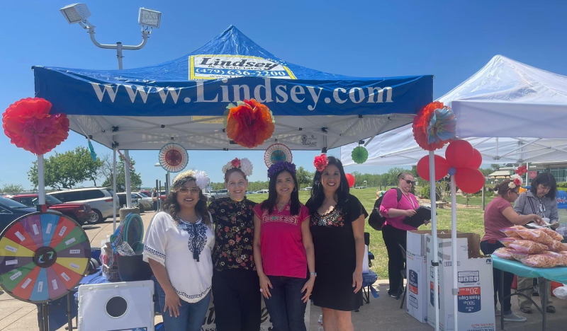 Lindsey team posing in tent at the 2022 Cinco de Mayo Community Event